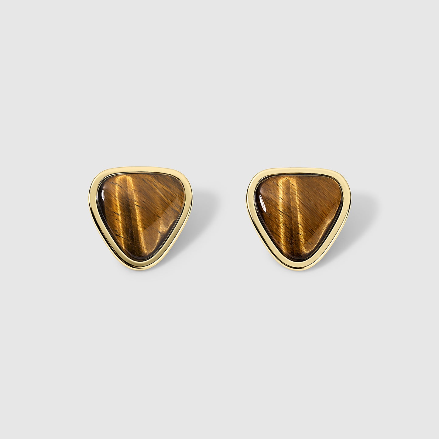 Pair of tiger eye stud earrings with a teardrop-shaped design featuring polished brown tiger eye gemstones framed in gold metal, displayed on a light gray background. Elegant and earthy, perfect for both casual and formal wear.